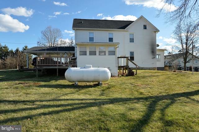 rear view of house with a lawn and a deck