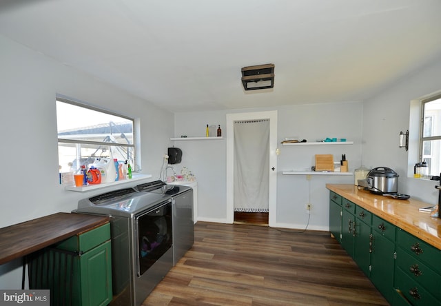 clothes washing area with independent washer and dryer and dark hardwood / wood-style flooring