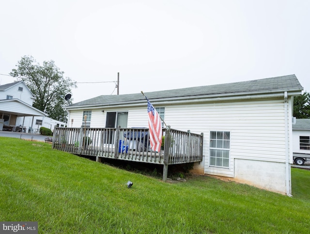 back of property featuring a yard and a deck