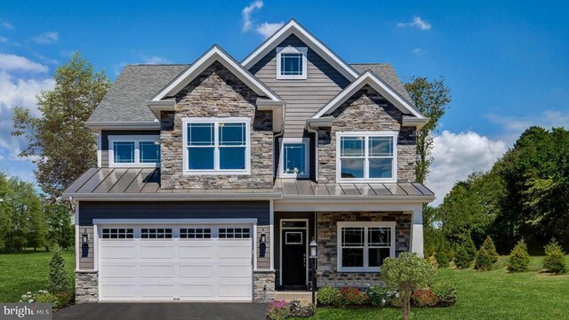 craftsman-style house with a garage and a front lawn