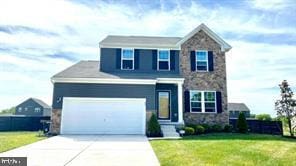 view of front of home featuring a garage and a front yard