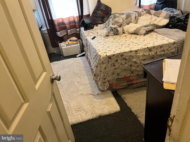 bedroom featuring carpet and an AC wall unit