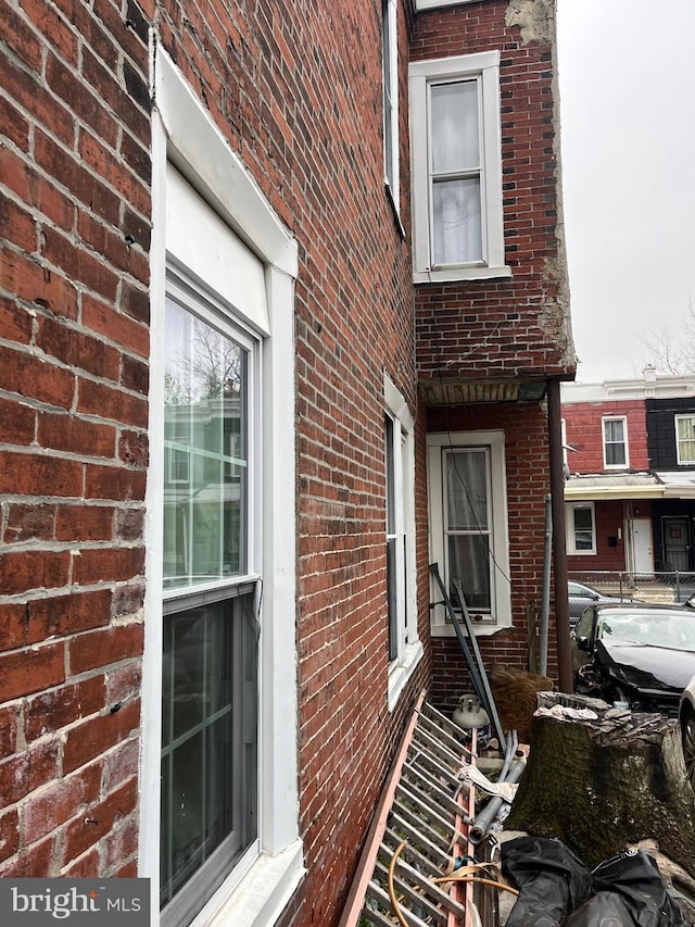 view of property exterior with brick siding