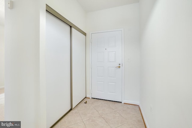 corridor featuring light tile patterned flooring