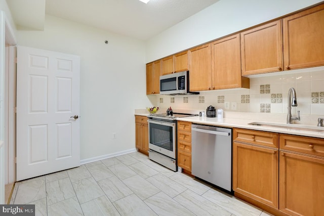 kitchen featuring decorative backsplash, sink, and stainless steel appliances