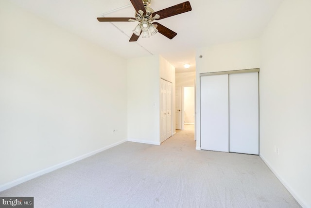 unfurnished bedroom featuring ceiling fan and light carpet