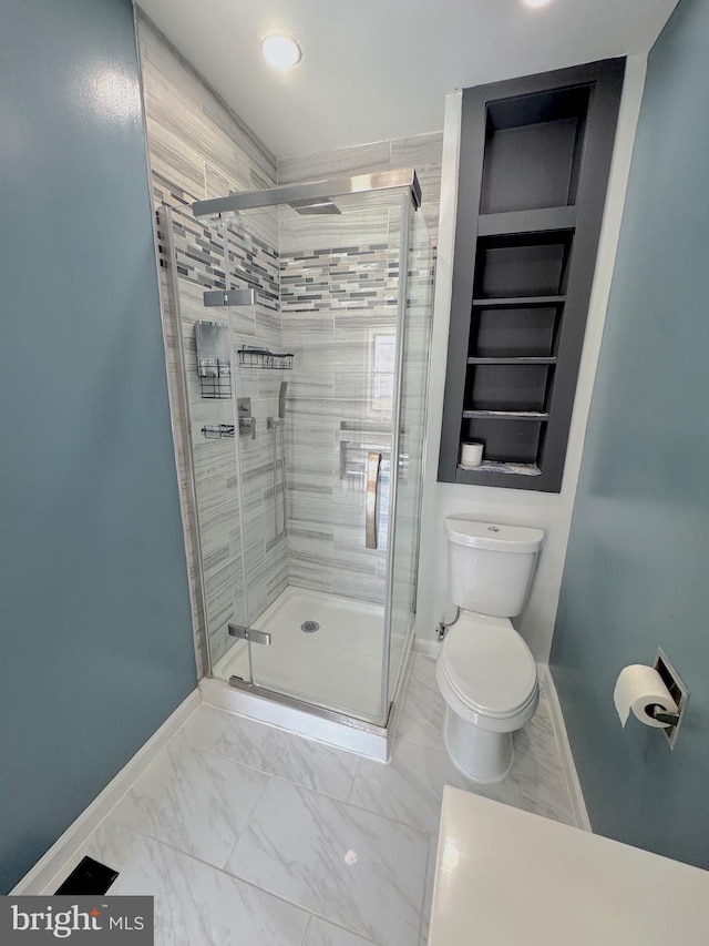 bathroom with marble finish floor, baseboards, a shower stall, and toilet