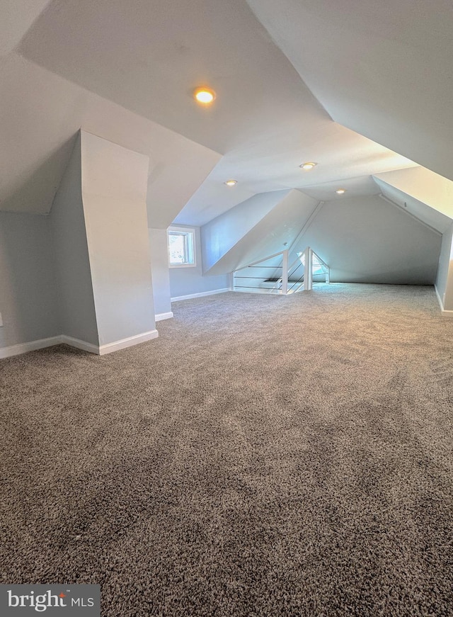 additional living space featuring carpet floors, lofted ceiling, baseboards, and recessed lighting