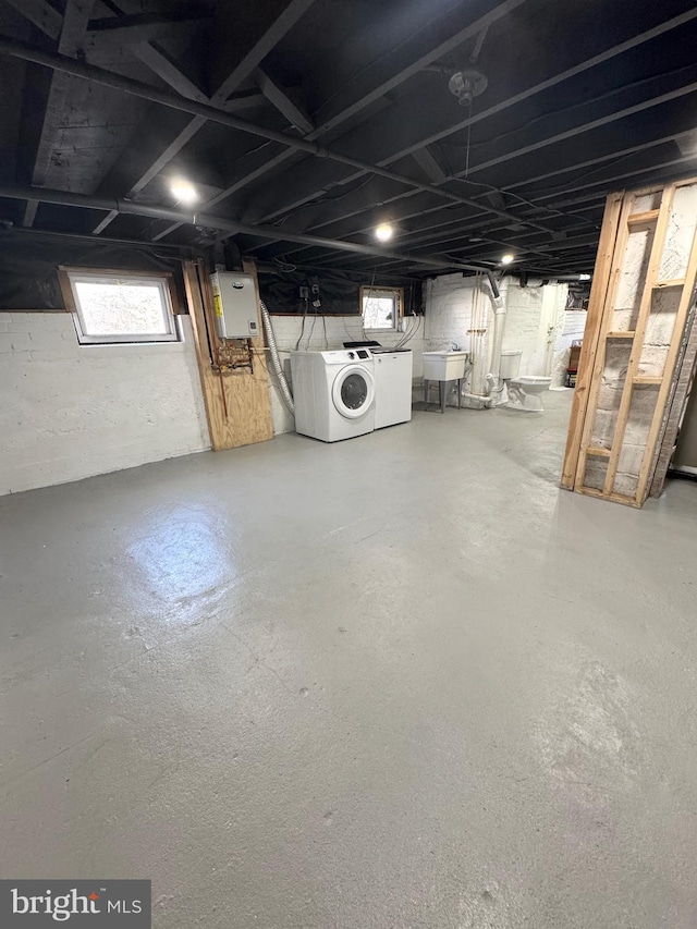 basement featuring a sink and washer and dryer