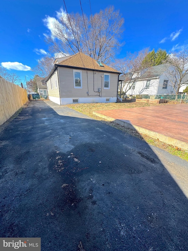 view of side of home featuring fence