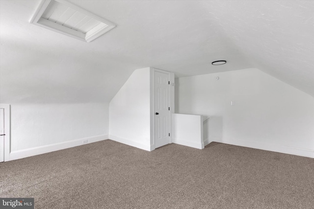 additional living space with carpet and lofted ceiling