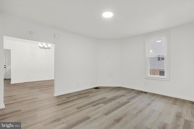 spare room featuring light hardwood / wood-style flooring