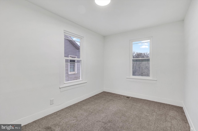 unfurnished room with carpet flooring