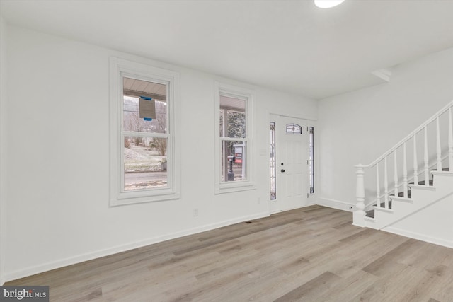 entrance foyer featuring light hardwood / wood-style floors and a healthy amount of sunlight