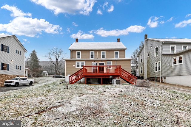 rear view of house with central AC and a wooden deck