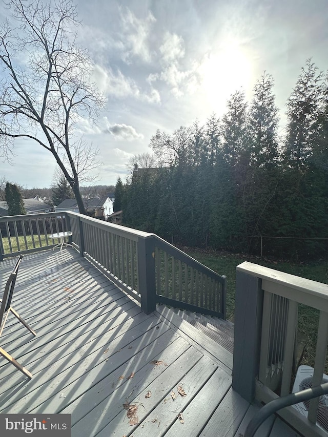 wooden deck with central AC unit