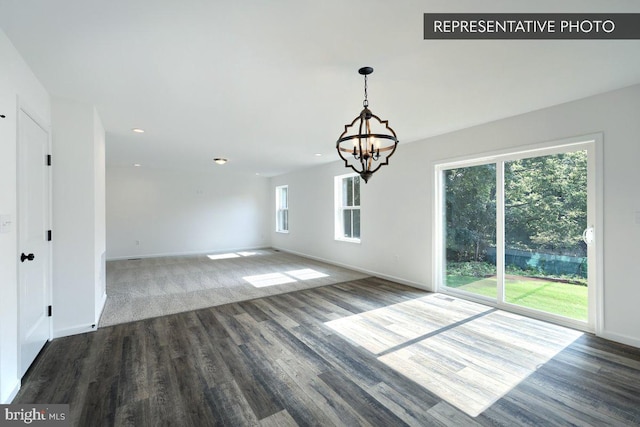 interior space with dark wood-type flooring and a notable chandelier