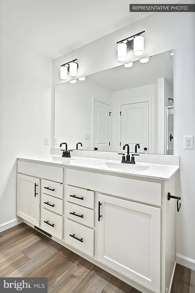 bathroom featuring hardwood / wood-style floors and vanity