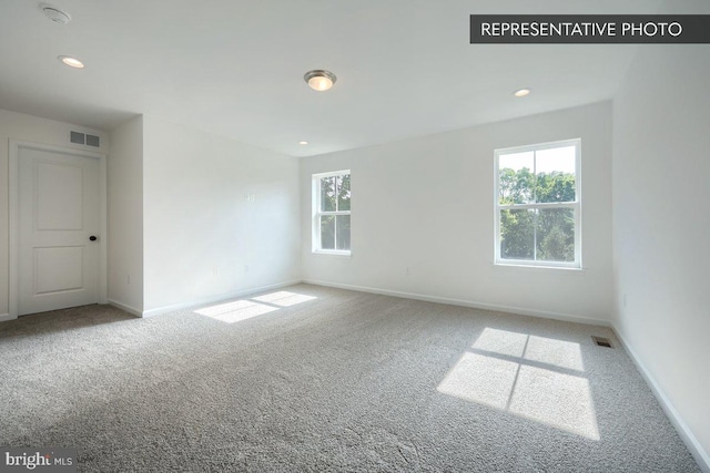 unfurnished room featuring carpet