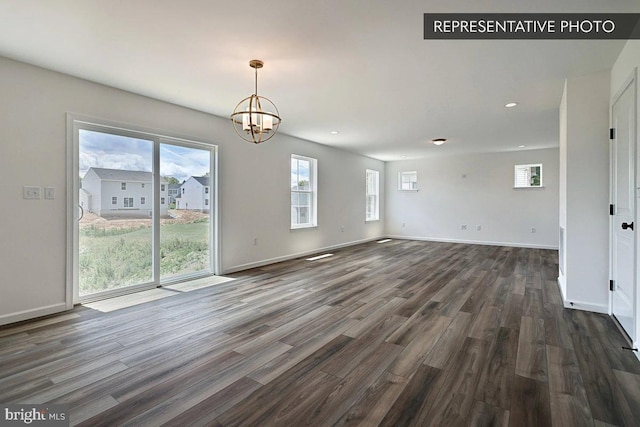 interior space with dark hardwood / wood-style flooring and an inviting chandelier