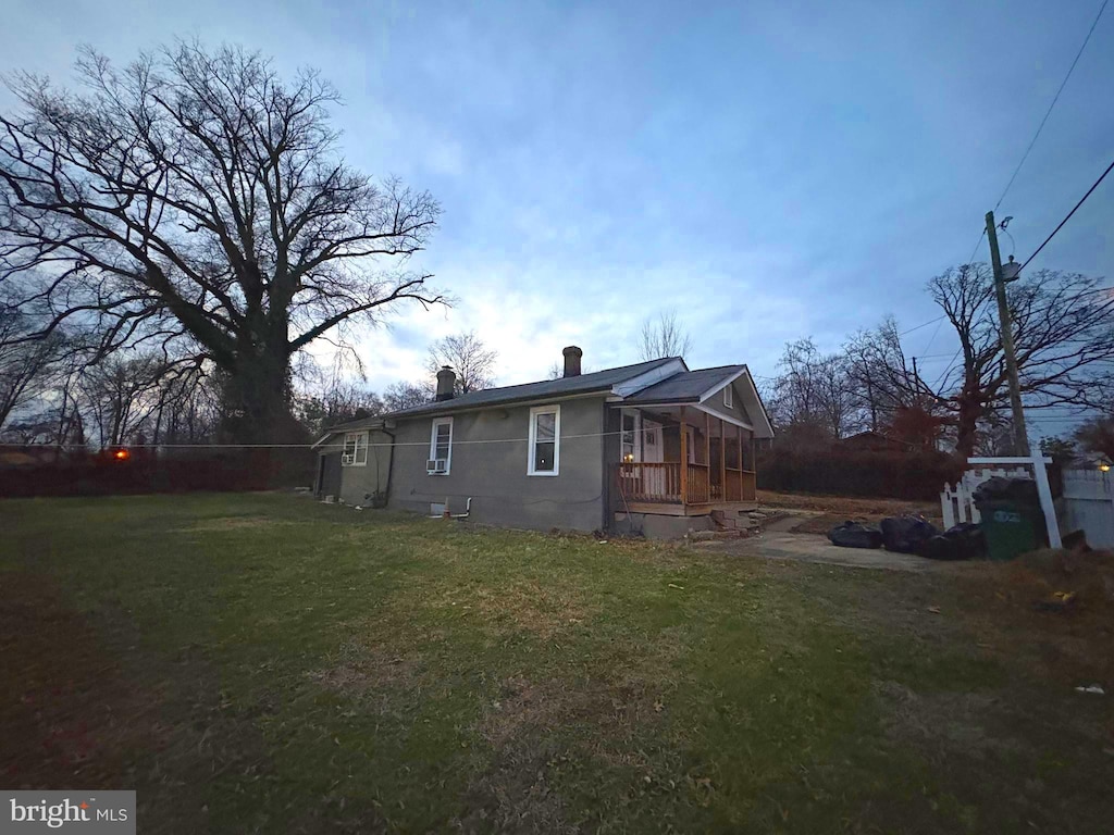 rear view of house with a yard