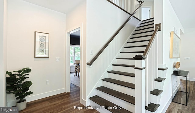 stairway with hardwood / wood-style floors