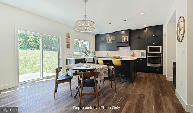 dining area featuring dark hardwood / wood-style flooring and a chandelier