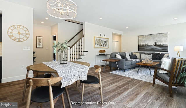 dining space featuring dark wood-type flooring and a notable chandelier