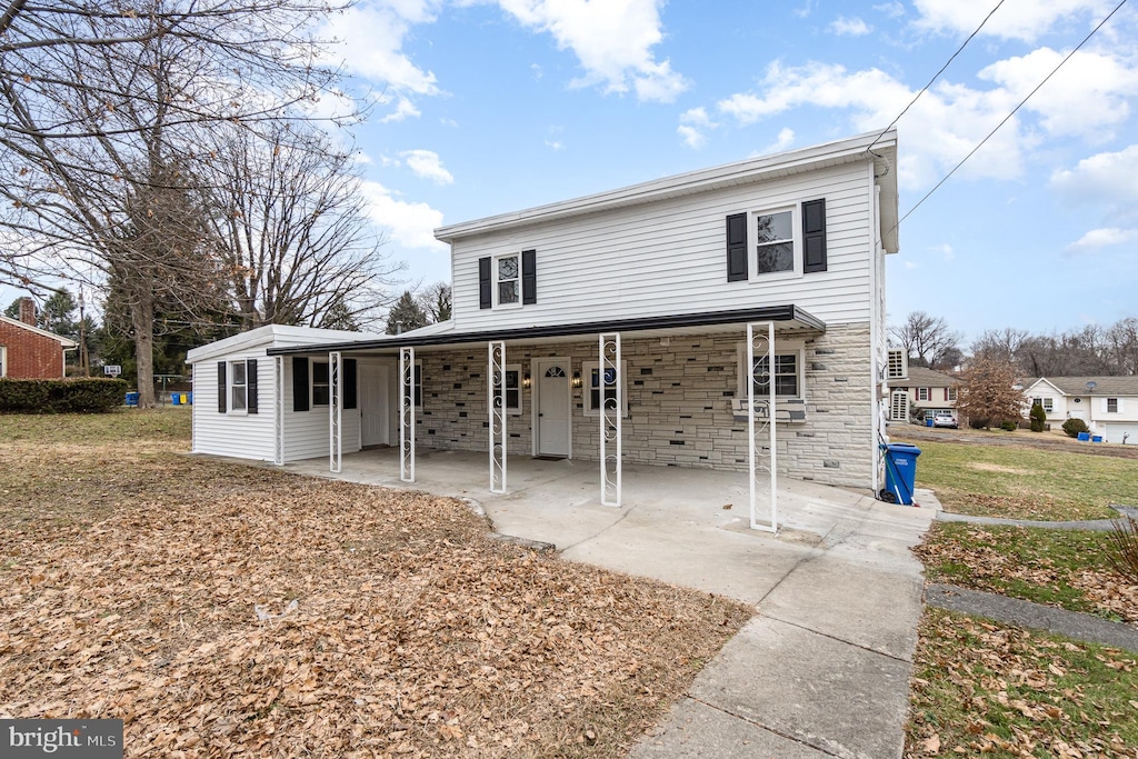 rear view of house featuring a yard