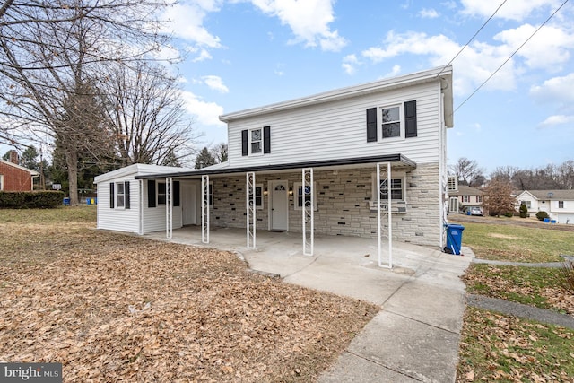 rear view of house featuring a yard