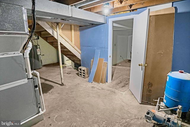 basement featuring electric water heater and heating unit