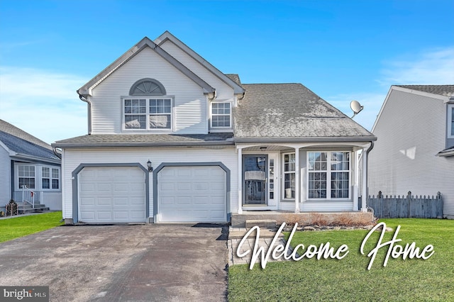 view of front of home featuring a front yard and a garage