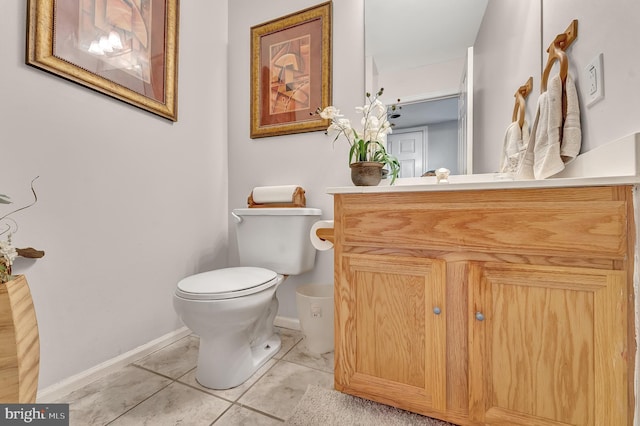 bathroom featuring tile patterned flooring, vanity, and toilet