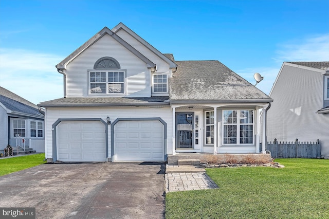 view of front of property with a garage and a front lawn