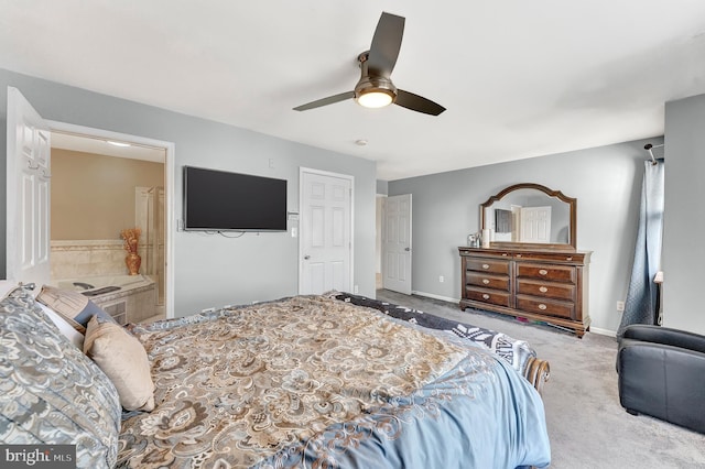 carpeted bedroom featuring ceiling fan and ensuite bathroom