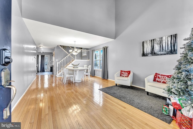 living room with wood-type flooring and a notable chandelier