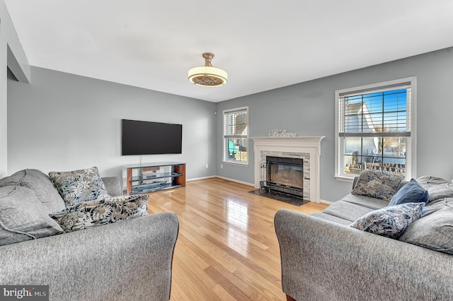 living room with a wealth of natural light and hardwood / wood-style flooring