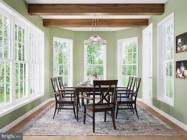 sunroom featuring beamed ceiling and plenty of natural light