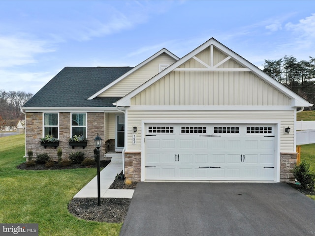 craftsman-style house with a garage and a front lawn