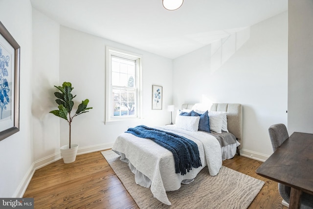 bedroom with dark hardwood / wood-style floors