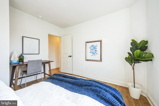 bedroom with hardwood / wood-style flooring