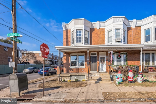 townhome / multi-family property featuring a porch