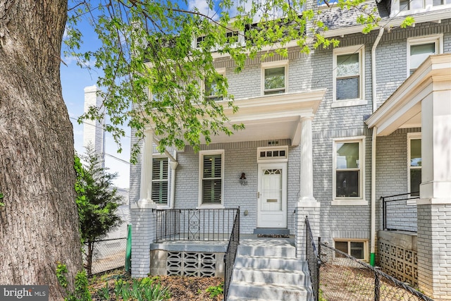 931 Farragut St NW, Washington, DC 20011 - view of front facade with a porch, brick siding, and fence