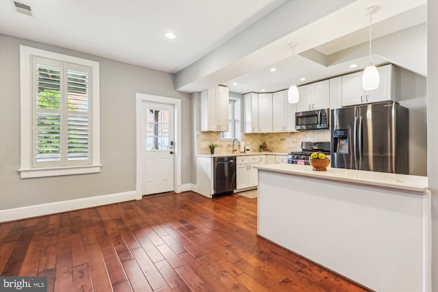 931 Farragut St NW, Washington, DC 20011 - kitchen with light countertops, white cabinets, appliances with stainless steel finishes, and a wealth of natural light