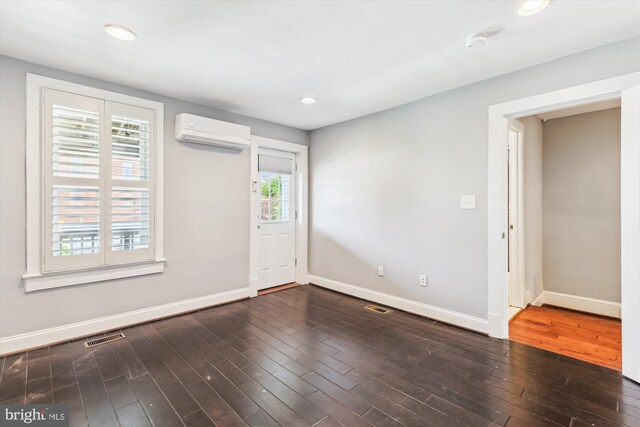 931 Farragut St NW, Washington, DC 20011 - unfurnished room featuring visible vents, baseboards, recessed lighting, a wall unit AC, and hardwood / wood-style flooring