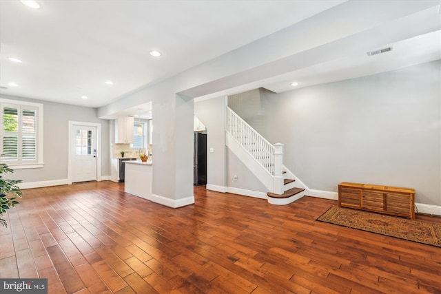 931 Farragut St NW, Washington, DC 20011 - unfurnished living room with visible vents, stairs, wood finished floors, and a healthy amount of sunlight