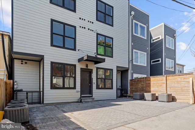 rear view of property with a patio area and central air condition unit