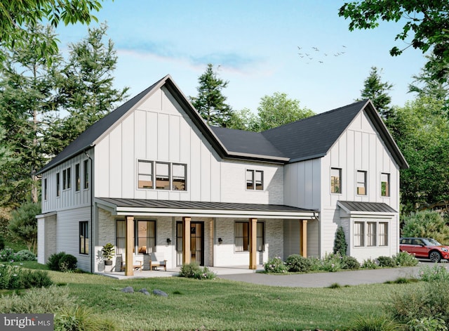 modern farmhouse style home featuring a front lawn and covered porch