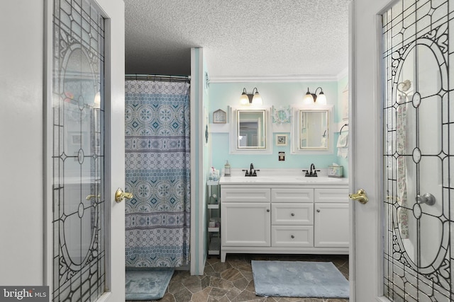 bathroom featuring a shower with shower curtain, a textured ceiling, vanity, and crown molding