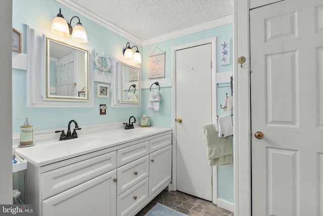 bathroom with vanity, a textured ceiling, and ornamental molding